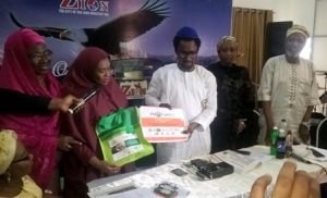 Project Director, Farida Sada Yusuf handing over PACFaH kit to Dr. Akinnadewo, sec. OAIC in Lagos during the visit.
